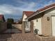 Side view of house showing gated access and brick exterior at 8608 Alfano Ct, Las Vegas, NV 89117