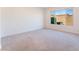 Spacious bedroom with neutral carpeting and large window at 8648 Cloverbelle St, Las Vegas, NV 89166