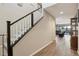 Elegant staircase with dark wood railing and hardwood floors at 996 Alverstone Ct, Henderson, NV 89002