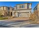 Two story house with gray siding, tan garage door, and a brick paver driveway at 1016 Greyhound Ln, Henderson, NV 89015