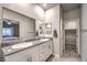 Double vanity bathroom with a walk-in closet at 10185 Sequoia Falls Pl, Las Vegas, NV 89149