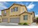 Tan two-story house with gray garage door and balcony at 1132 Via Fellini, Henderson, NV 89052