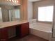 Bathroom with double sinks, large tub, and separate shower at 3817 Bella Legato Ave, North Las Vegas, NV 89081