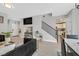 Open concept living room with stairs, dark furniture, and wood-look floors at 5515 Gold Mint Ln, Las Vegas, NV 89122