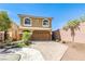 Two-story house with a brown garage door and landscaped yard at 6093 Crown Palms Ave, Las Vegas, NV 89139