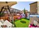 Charming backyard with playground and artificial turf at 7023 Bering Strait Ave, Las Vegas, NV 89179