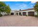 Four-car garage with dark brown doors and brick pavers at , Las Vegas, NV 89118