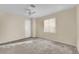 Spacious bedroom with gray carpet and a window with blinds at 10646 Shifting Breeze Ave, Las Vegas, NV 89129