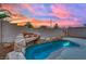 Relaxing backyard pool with a rock waterfall feature at 10646 Shifting Breeze Ave, Las Vegas, NV 89129