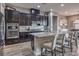 Spacious kitchen with dark cabinetry, granite countertops, and stainless steel appliances at 3428 Isle Dr, Las Vegas, NV 89141