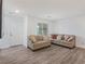 Spacious living area featuring a corner sofa and wood-look floors at 3585 Arcadian Sea St, Las Vegas, NV 89106