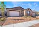 Modern home exterior with a two-car garage and well-maintained landscaping at 360 Haddocks Hall Pl, Henderson, NV 89011