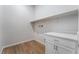 Laundry room with white cabinets and wood-look flooring at 360 Haddocks Hall Pl, Henderson, NV 89011