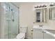 Clean bathroom with a walk-in shower and marble-tiled walls at 3665 Bronco Rd, Las Vegas, NV 89103