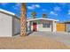 Newly remodeled home with red door and landscaped yard at 4306 Swandale Ave, Las Vegas, NV 89121