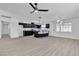 Modern kitchen with island and living room with vinyl flooring at 4306 Swandale Ave, Las Vegas, NV 89121