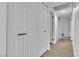 Hallway with white doors and hardwood floors at 5512 Burntwood Way, Las Vegas, NV 89108