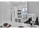 Modern kitchen with white shaker cabinets, stainless steel appliances, and quartz countertops at 5512 Burntwood Way, Las Vegas, NV 89108