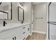 Bathroom with double vanity, quartz countertop, and modern fixtures at 6024 Tokara Ave, Las Vegas, NV 89122