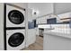 Stackable washer and dryer tucked away in a closet at 709 Osprey Cir, Las Vegas, NV 89107