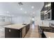 Modern kitchen with dark cabinetry and large island at 9570 Thistle Creek Ave, Las Vegas, NV 89178