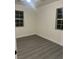 Spacious bedroom with two windows and new flooring at 116 W Victory Rd, Henderson, NV 89015