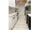 Stylish kitchen featuring white cabinets and marble backsplash at 116 W Victory Rd, Henderson, NV 89015