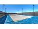 Well-lit tennis court with blue surface and fencing at 1589 Dom River Dr # Lot 121, North Las Vegas, NV 89084