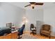 Home office with wood desk and comfortable chair at 1704 Nestled Meadows Ln, Las Vegas, NV 89128