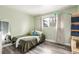 Bright bedroom with a double bed, wood-look floors, and a large window at 232 Colleen Dr, Las Vegas, NV 89107