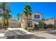 Tan two-story house with palm trees, driveway, and landscaped yard at 2383 Falsetto Ave, Henderson, NV 89052