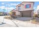 Two-story house with brown garage door and orange shutters at 301 La Musica Pl, Henderson, NV 89015