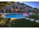 Resort-style backyard with a circular pool, spa, and lush landscaping at 4202 San Alivia Ct, Las Vegas, NV 89141