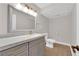 Updated bathroom features gray vanity, marble countertop, and new lighting at 4941 Tierra Del Sol Dr, Las Vegas, NV 89113