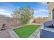 Artificial turf backyard with brick pavers and grill at 6288 Sledgehammer Ct, North Las Vegas, NV 89081