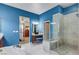 Bathroom with blue walls, marble flooring, and a large walk-in shower at 7017 Arcadia Creek St, North Las Vegas, NV 89084