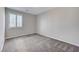 Well-lit bedroom featuring grey carpet and window shutters at 705 Sunrise Cliffs St, Henderson, NV 89014