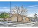 Tan one-story house with a two-car garage and landscaped yard at 9539 Brewing Cloud Ave, Las Vegas, NV 89148