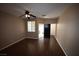 Living room with dark laminate floors and a ceiling fan at 10415 Palm Village St, Las Vegas, NV 89183