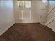 Living room with stairs and large windows, carpeted floor at 1601 Paloma Ave, Laughlin, NV 89029