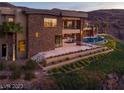 Back exterior of modern home overlooking the pool at 761 Dragon Ridge Dr, Henderson, NV 89012