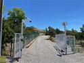 Gated entrance to a property with a security camera at 18475 Mater Mea Pl, Mountain Springs, NV 89161