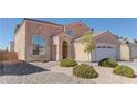 Two story house with two car garage and landscaping at 2619 Paradise Isle Ave, North Las Vegas, NV 89031