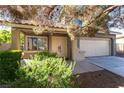 House exterior view with landscaping and two-car garage at 10301 Horseback Ridge Ave, Las Vegas, NV 89144