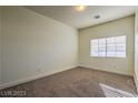 Simple bedroom with neutral walls and carpeted floors at 5148 Guardian Peak St, Las Vegas, NV 89148