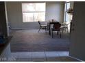 Dining area features wood-look flooring and a view to the living room at 3711 Southern Light Dr, Las Vegas, NV 89115