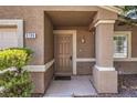 Brown front door with columns and landscaping at 5199 Mineral Lake Dr, Las Vegas, NV 89122