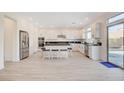 Modern kitchen with white cabinets and a large island at 8749 Black Cordon Rd, Las Vegas, NV 89139