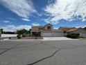 Two-story house with a three-car garage and landscaping at 1003 Dover Glen Dr, North Las Vegas, NV 89031