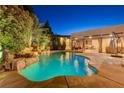 Inviting pool area with a waterfall feature and patio seating at 8275 W Craig Rd, Las Vegas, NV 89129